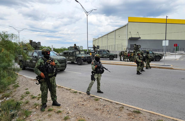Soldiers guard a crime scene where five men were killed following a chase, in Nuevo Laredo 
