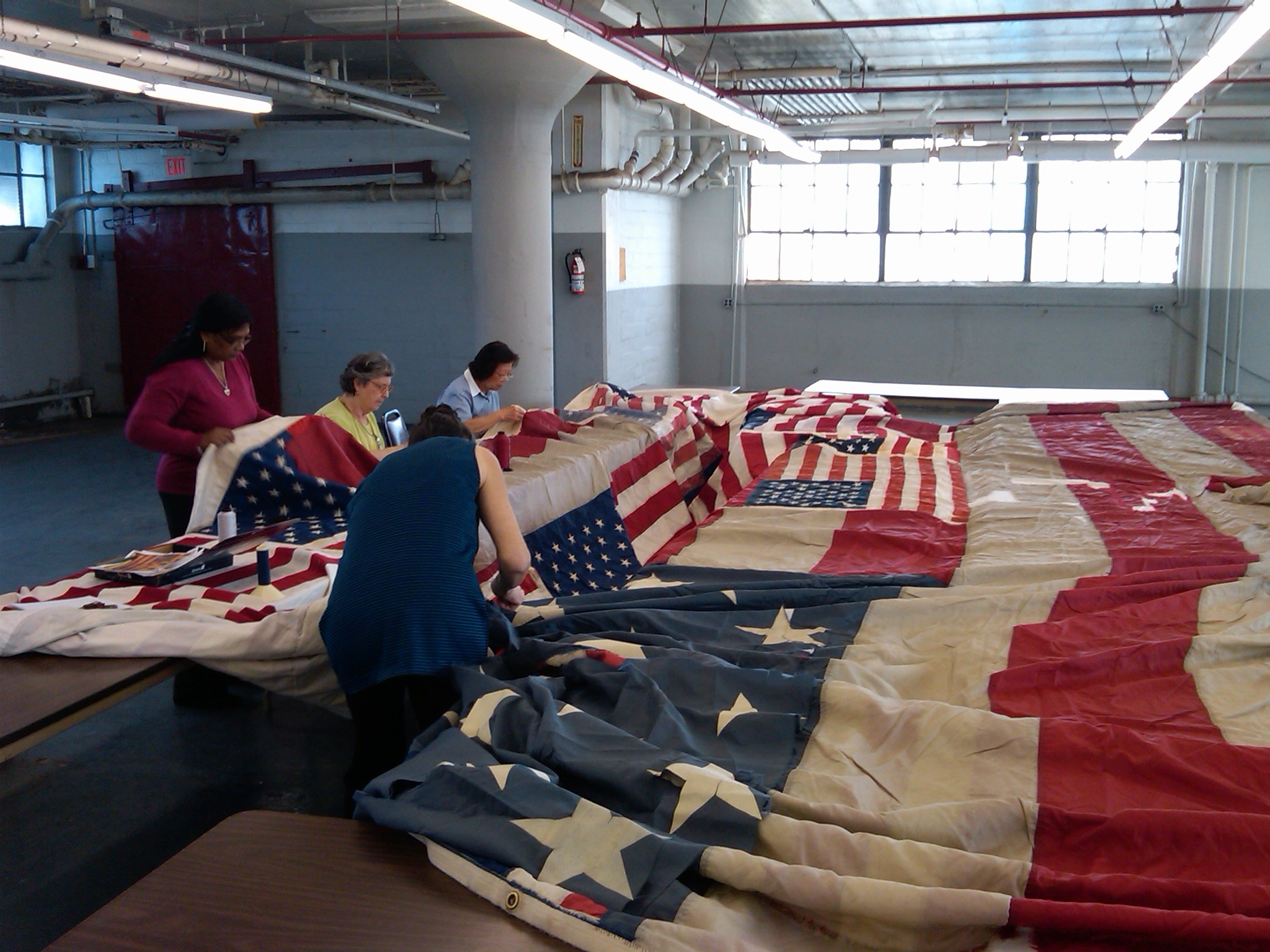 Seamstresses work to repair the 9/11 flag (credit: Peter Haskell/WCBS 880) 