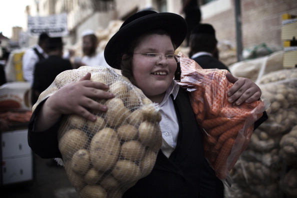 An ultra-Orthodox Jewish boy carries don 