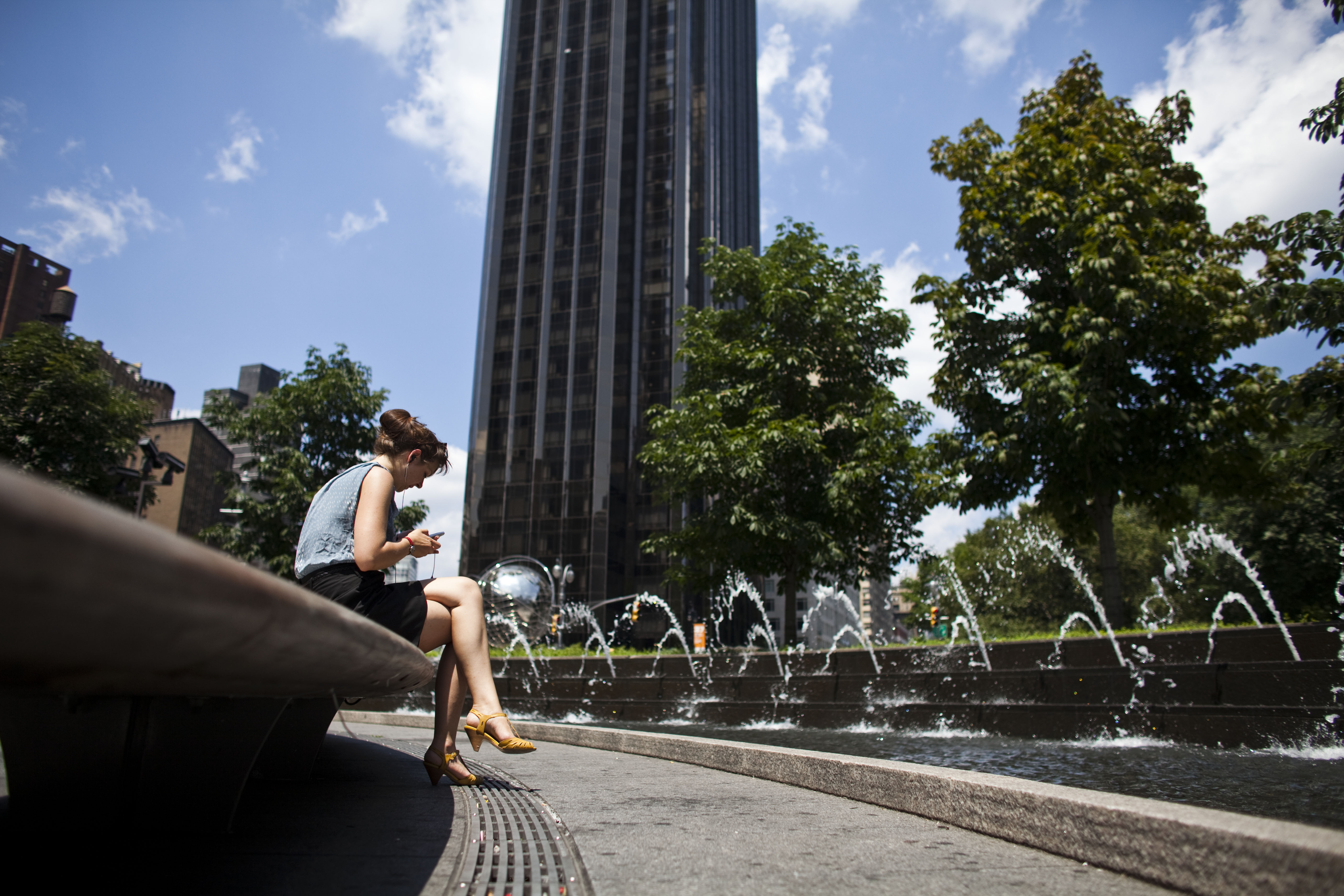 A Woman Sits By The Fountains At Columbus Circle 