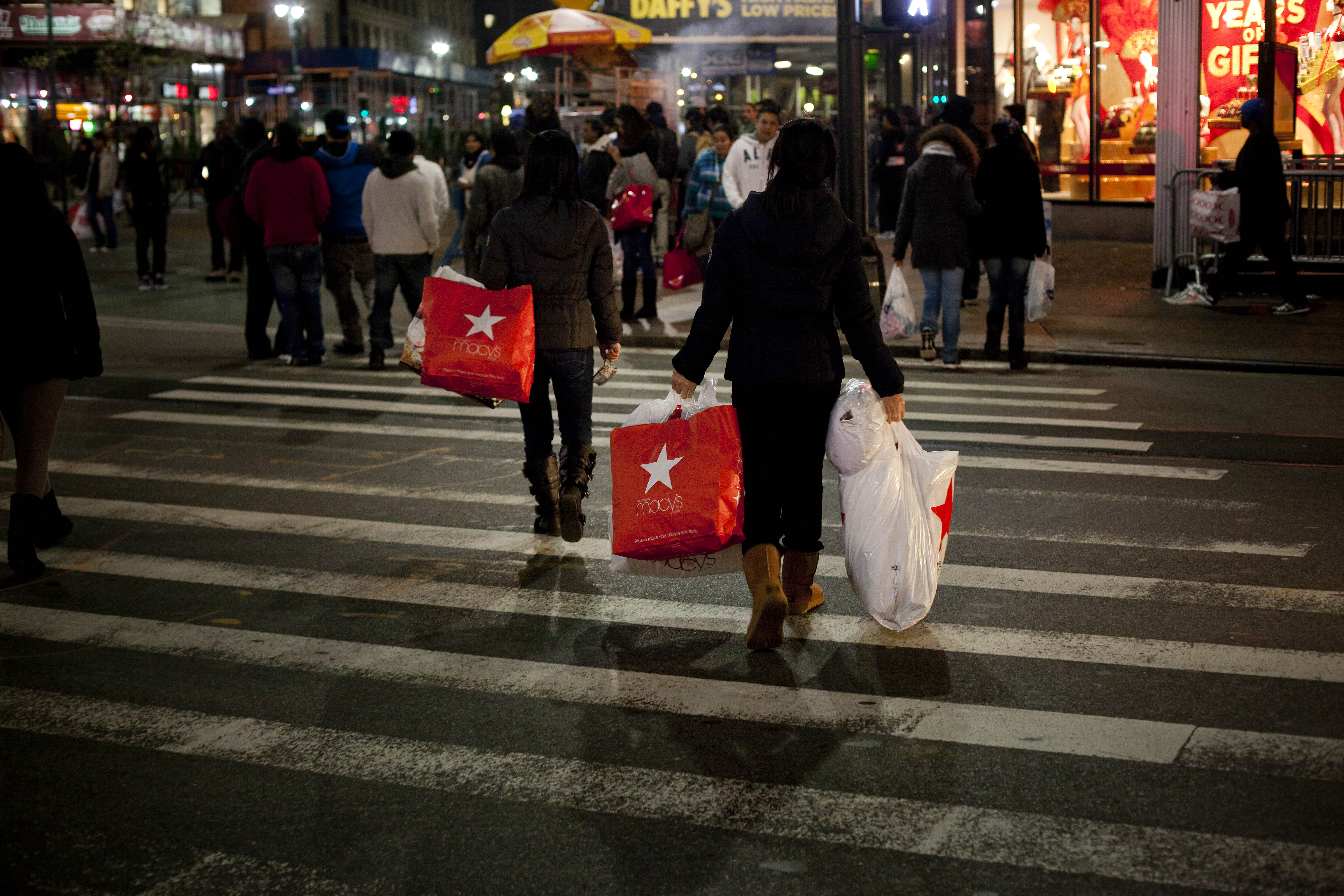 Black Friday shoppers crossing street 