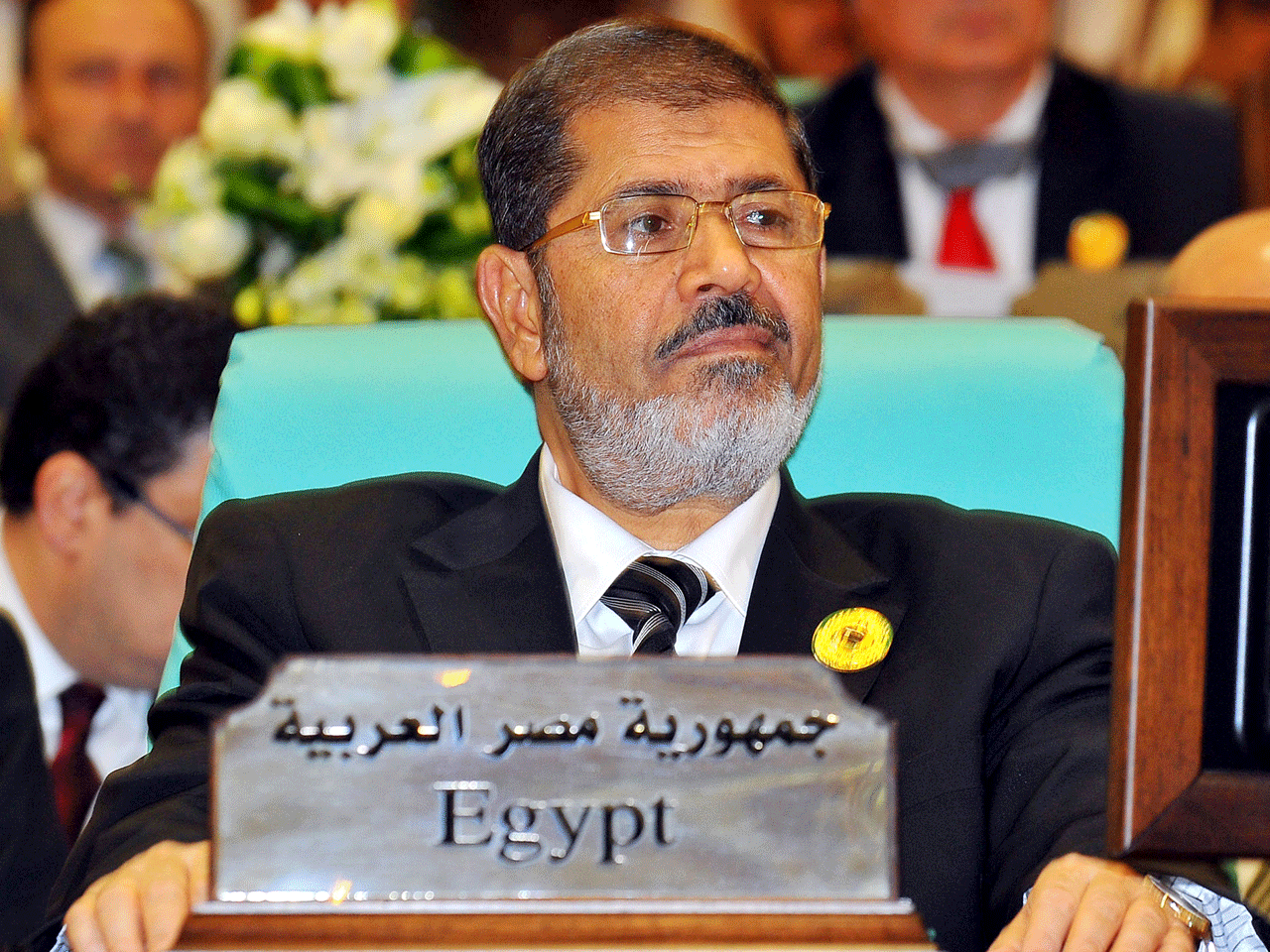 In this photo released by Saudi Press Agency, Egyptian President Mohammed Morsi attends the opening of an extraordinary session of the Organization of Islamic Conference in Mecca, Saudi Arabia, Tuesday, Aug. 14, 2012 