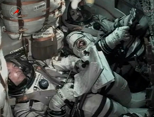 Soyuz TMA-14M commander Alexander Samokutyaev, left, and cosmonaut Elena Serova monitor computer displays during their climb to orbit Thursday. Astronaut Barry "Butch" Wilmore is out of view to the left 