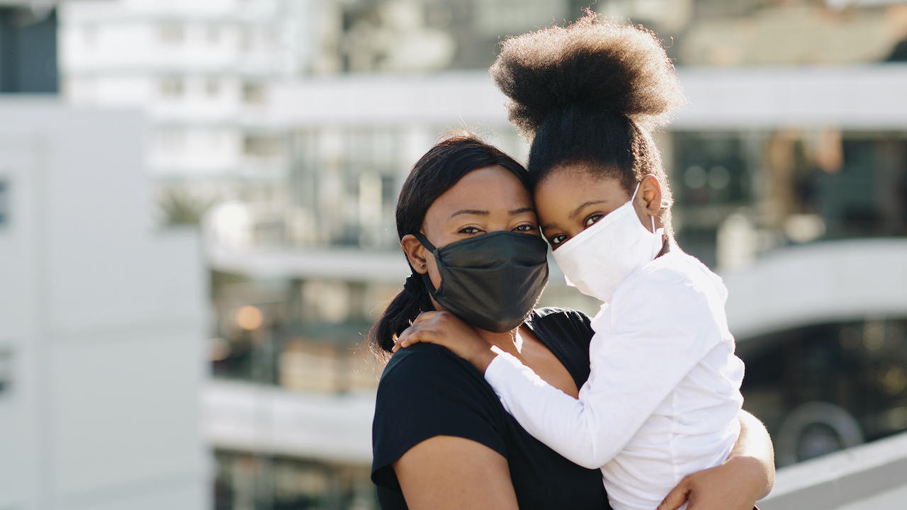 mother and daughter wearing masks 