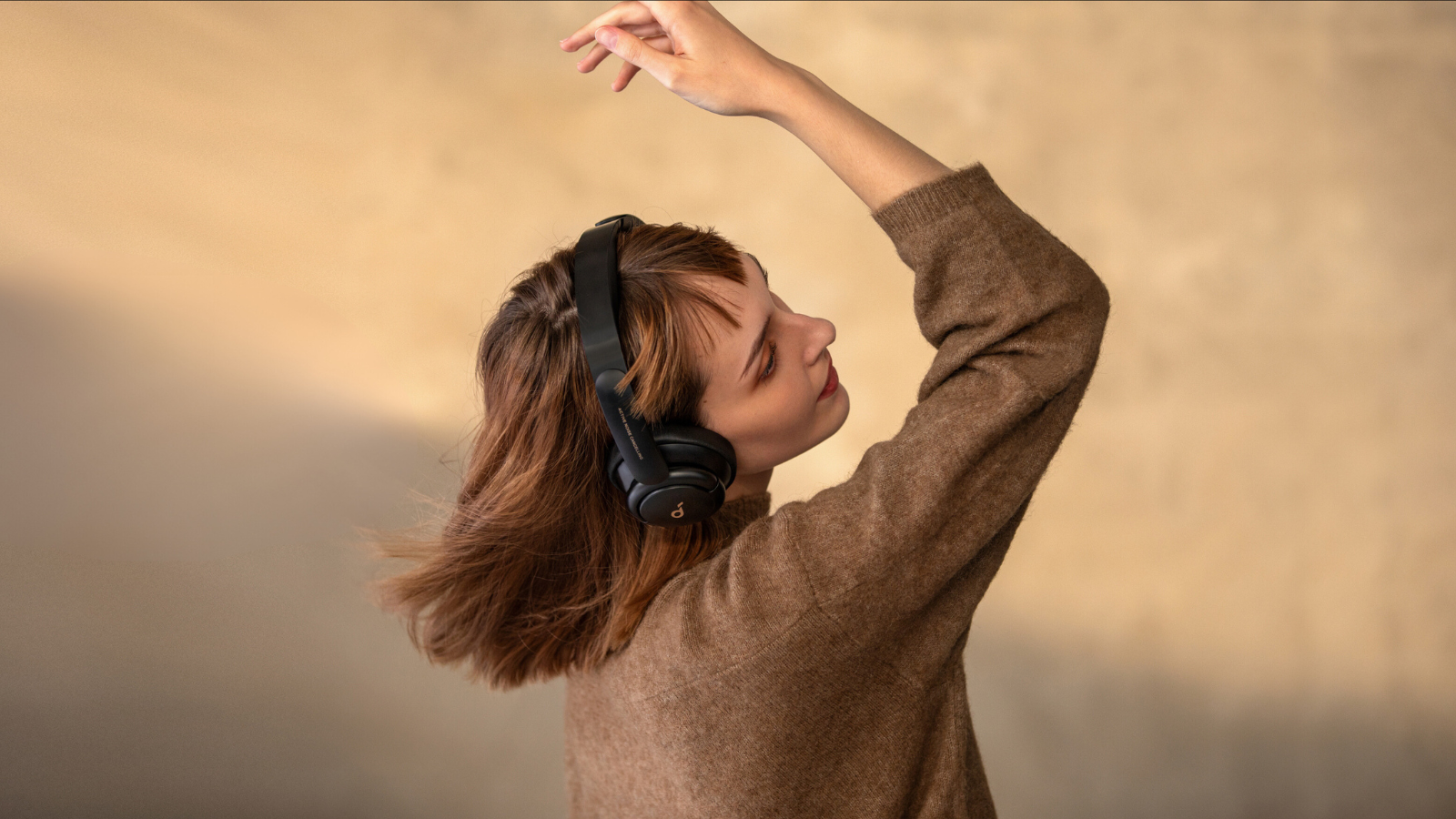 Woman wearing Anker Soundcore headphones 