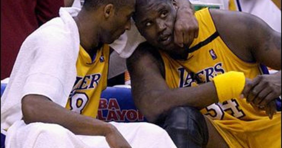 Los Angeles Lakers Kobe Bryant, left, holding the championship trophy,  celebrates with teammates Rick Fox, Lindsey Hunter, second from right, and  Shaquille O'Neal, right, holding the MVP trophy, after winning Game 4