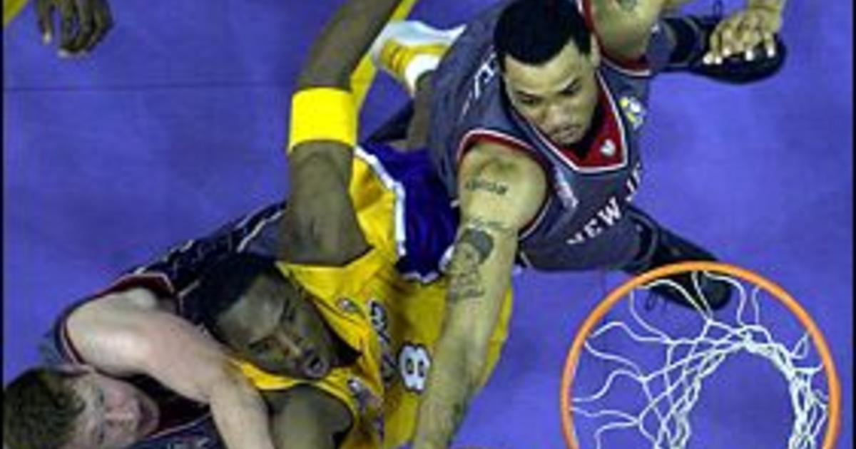 Utah Jazz forward Andrei Kirilenko, of Russia, stops Los Angeles Lakers  guard Kobe Bryant, left, during the fourth quarter Wednesday, Dec. 4, 2002,  in Salt Lake City. The Jazz won 93-85. (AP