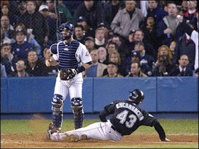 New York Yankees catcher Jorge Posada tags out Florida Marlins Ivan  Rodriguez after a run down between third and home during game 3 of the 2003  MLB World Series, at Pro Player