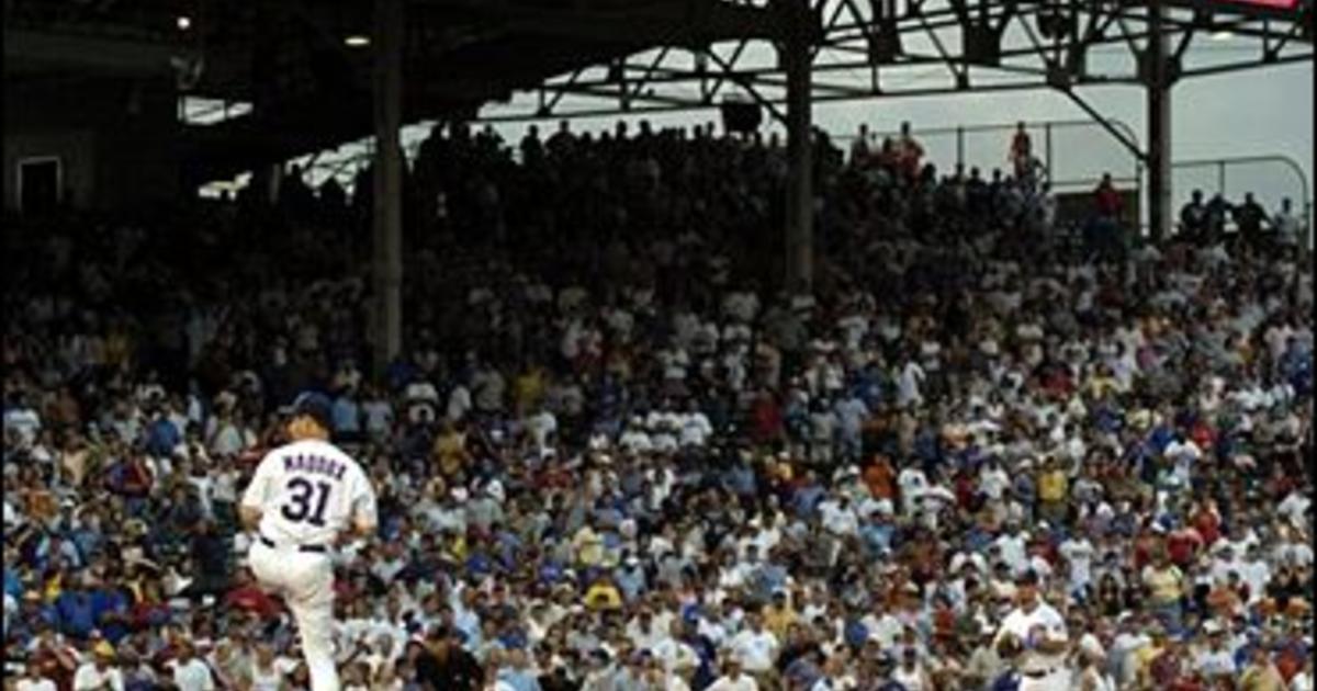 Montreal Expos' Tony Batista, left, celebrates with first base