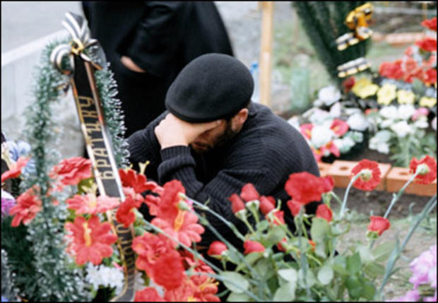 Grief is universal at the Beslan cemetery for victims of the September 2004 siege. 