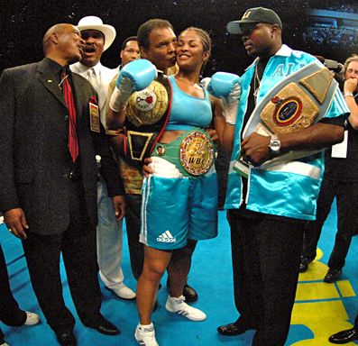 Laila Ali receives a kiss from her father 