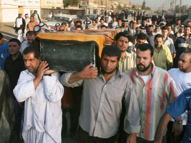 Iraqi men carry coffin 