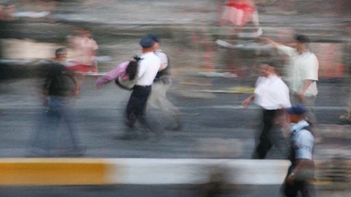policeman carries an injured woman 