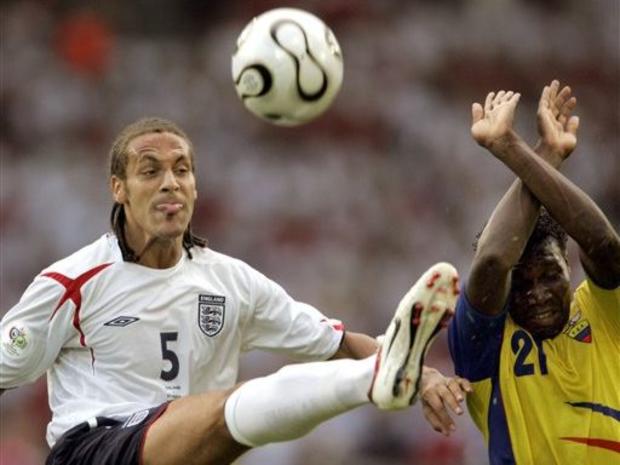 England's Rio Ferdinand, left, clears the ball from Ecuador's Carlos Tenorio 
