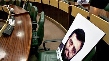 Portraits of lawmakers held in Israeli jails sit on the empty Palestinian parliament 