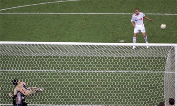 Italy's goalkeeper Gianluigi Buffon, left, and France's David Trezeguet look on as Trezeguet's kick hits the cross bar during the shoot out 