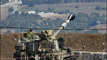 An Israel artillery piece prepares to fire into Lebanon from a position on the border near the town of Moshav Margaliyot, Israel, Wednesday, July 12, 2006. 