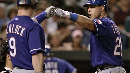 Texas Rangers' Mark Teixeira, right, is congratulated by teammate Hank Blalock 