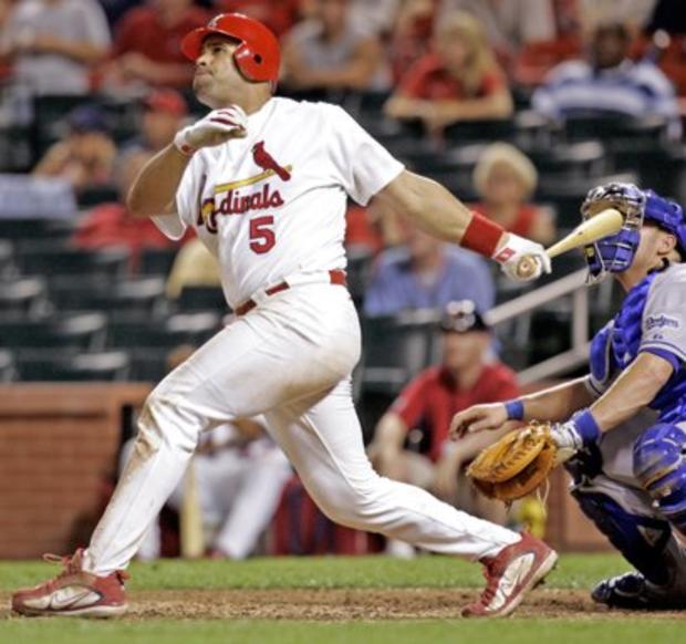 St. Louis Cardinals' Albert Pujols watches the flight of his 14th-inning solo home run 