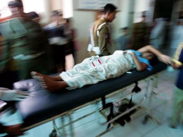 An Indonesian tsunami victim is rushed into a hospital emergency room 