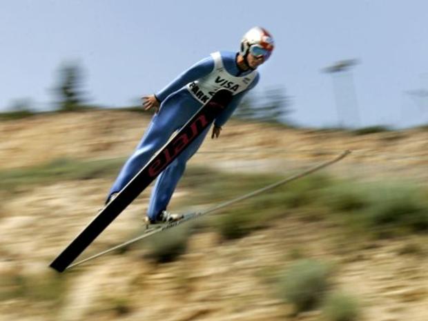 USA's Alissa Johnson sails past desert vegetation and barren rock during a hot summer day on a practice run on the K90 ski jump 