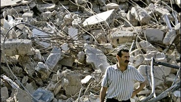 A man pauses as he inspects the destruction in the center of the southern market town of Nabatiyeh 