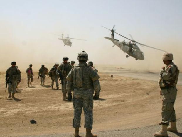 A combined raid of U.S. and Iraqi troops touch down in a landing zone, Thursday, July 20, 2006, on the outskirts of Kirkuk, 290 kilometers (180 miles) north of Baghdad, Iraq. 