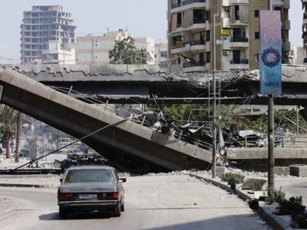 A demolished flyover is covered in debris after being targeted by Israeli air strikes 