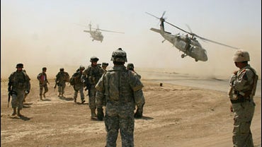 A combined raid of U.S. and Iraqi troops touch down in a landing zone, Thursday, July 20, 2006, on the outskirts of Kirkuk 