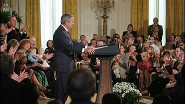 Bush vetoes stem cell research funding bill, surrounded by couples that adopted frozen embryo babies, 7-19-06 
