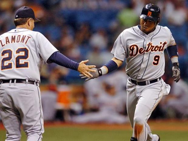 Detroit Tigers third base coach Gene Lamont congratulates Carlos Guillen (9) as he circles the bases after hitting a solo home run 