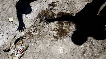 Scotty Nguyen throws away his cards while playing a hand at the World Series of Poker 