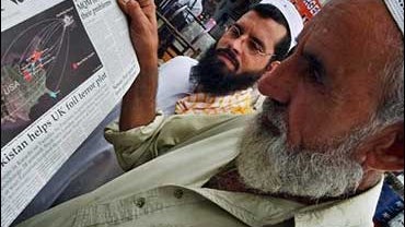 Pakistani men read about Britain terror 