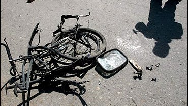Afghan policemen secure the scene where a roadside bomb exploted in Kabul, Afghanistan, Monday, Aug. 14, 2006. 