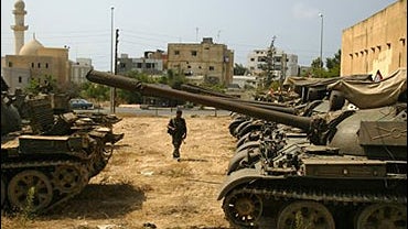 A Lebanese army soldier guards the area among parked Soviet-made T-54 tanks in the port city of Tyre, southern Lebanon 
