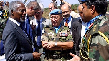 U.N. Secretary-General Kofi Annan talks to an Indian officer as French Maj. Gen. Alain Pellegrini, the U.N. Interim Force commander, center, looks on at a U.N. Interim Force base in Meis el Jabal, Tuesday, Aug. 29, 2006. 