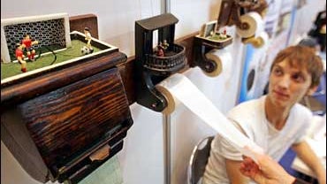 A visitor checks a handmade toilet paper dispenser at the 6th annual World Toilet Summit exhibition at Moscow's manege, 07 September 2006. 