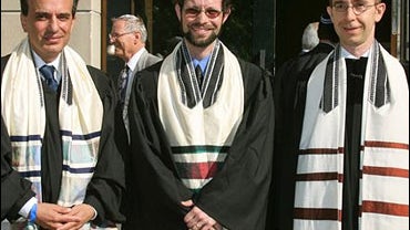 Future rabbis Daniel Alter from Germany, Malcolm Mattitiani from South Africa, and Tomas Kucera from the Czech Republic, from left to right, pose prior to their ordination in front of the new Synagogue in Dresden 