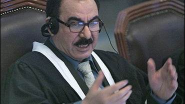Chief judge Abdullah al-Amiri addresses the court during Saddam Hussein's trial 