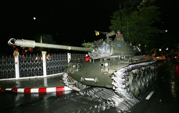 Thai soldiers ride on a tank next to Government house in Bangkok, Thailand, Tuesday Sept. 19, 2006. Rumors of a military coup swept the Thai capital after an army-owned television station suspended regular programming and played patriotic songs. 