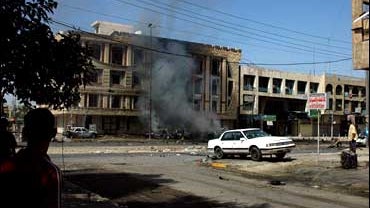 Smoke billows after a bomb exploded in a parked car, targeting a US military convoy in central Baghdad Sunday, Oct. 1, 2006. 