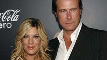 Actress Tori Spelling, left, and husband Dean McDermott pose together at the the launch party for interactive reality event "Gold Rush" in the Hollywood section of Los Angeles on Tuesday, Sept. 12, 2006. (AP Photo/Matt Sayles) 