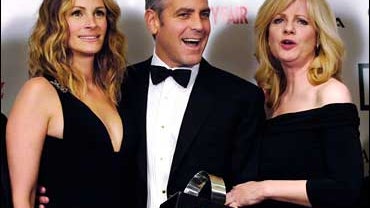 George Clooney holds his award backstage alongside actresses Julia Roberts, left, and Bonnie Hunt at the 21st Annual American Cinematheque Award gala honoring Clooney, in Beverly Hills, Calif., Friday, Oct. 13, 2006. 