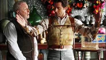 Cutter (Michael Caine) observes a new trick performed by magician Robert Angier (Hugh Jackman) in "The Prestige." 