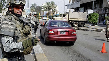 A US soldier operates a checkpoint setup around the Karrada neighbourhood in central Baghdad, October 31, 2006. 