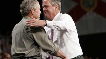 Florida Gov. Jeb Bush, right, hugs his brother, President Bush, left, after introducing him at a campaign rally at Pensacola Civic Center in Pensacola, Fla., Monday, Nov. 6, 2006. 