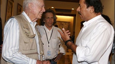 Daniel Ortega, former president of Nicaragua who appears to be the winner of the Nov. 5, 2006, national elections there, talks in Managua, Nicaragua, the next day with one of the many international observers of the election, U.S. president Jimmy Carter. 