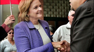 Missouri Democratic candidate for the U.S. Senate Claire McCaskill (C) greets a shopper while stumping for votes at a supermarket 