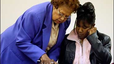 Democrat judge Irene Mason assists voter Denise Harris with her provisional ballot at Price Hall in Muncie, Ind., Tuesday, Nov. 7, 2006. 