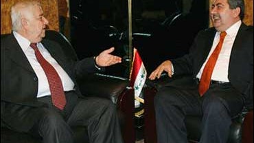 Iraq's Minister of Foreign Affairs Hoshyar Zebari, right, talks with visiting Syria's Foreign Minister Walid Moallem. 